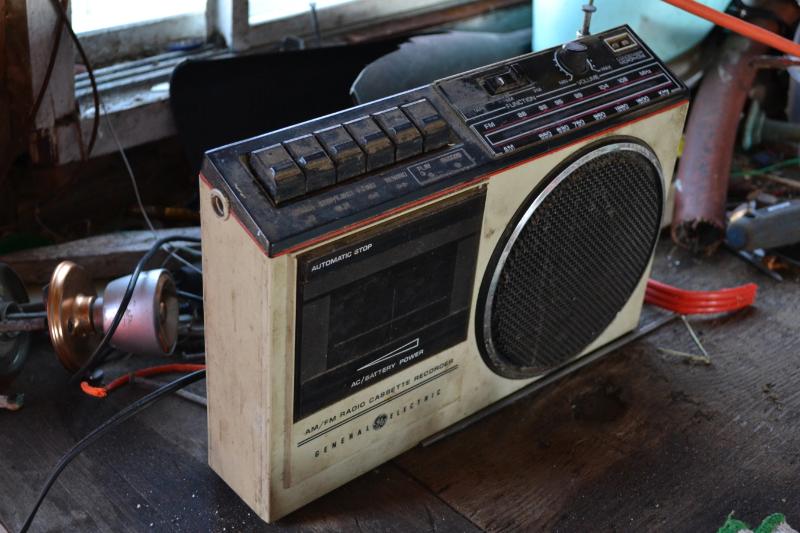 image of old silver coloured radio with a cassette player and applicable buttons on top