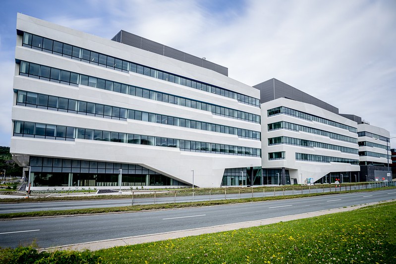 A photo of the outside of the Core Science Facility on Memorial University's St. John's campus. The building is white, with five floors and many windows.