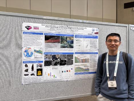 PhD student Ming Yang standing near his poster at the PDAC-SEG 2025 colloquium