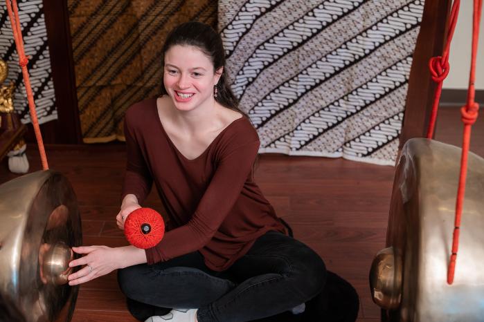 student playing gamelan instrument