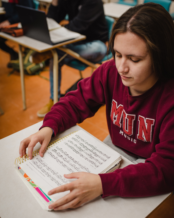 Photo of student studying wearing a MUN Music sweatshirt